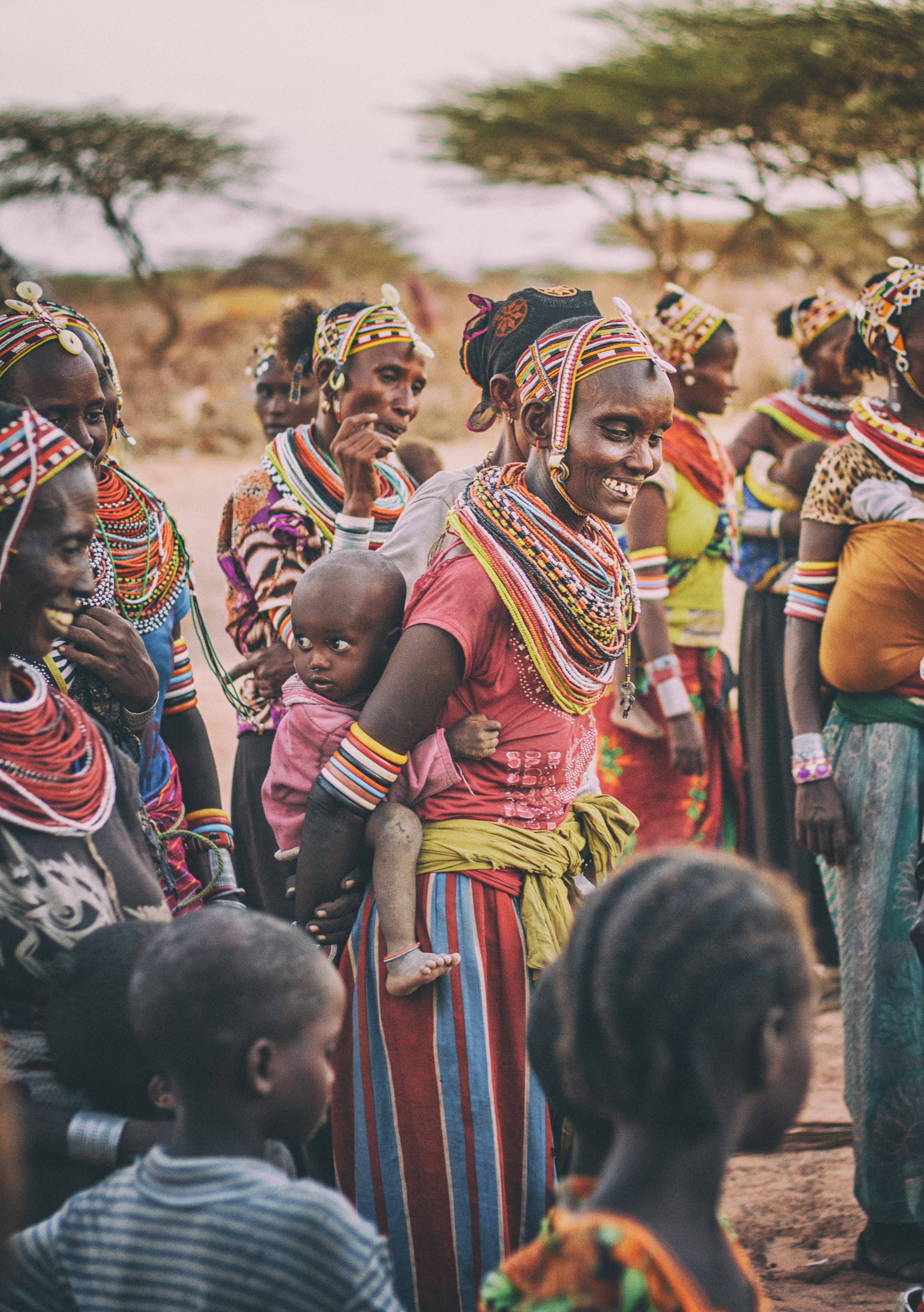 Kenyans in traditional clothing in village